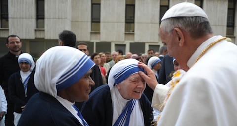 Pope Francis blesses a nun during visit to Missionaries of Charity soup kitchen and women's shelter at Vatican