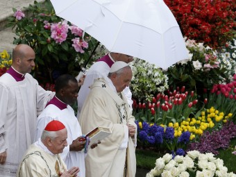 Pope Francis walks to altar during Easter Mass in St. Peter's Square at Vatican