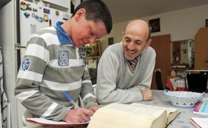 Right to Left - Palestinian Joseph Hazboun, 46, helps his son, Lene, 12, with his homework in their apartment in East Jerusalem, February 28, 2012. Joseph from Bethlehem, West Bank, has been living for 17 years with his wife, Rima, 45, (she refused to be photographed) who is from Jerusalem, without being granted a permanent residency to live with his family by the Israeli authorities. PHOTO: DEBBIE HILL