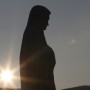 The sun sets behind a statue of Mary on Apparition Hill in Medjugorje, Bosnia-Herzegovina, in this 2011 file photo. (CNS photo/Paul Haring) See MEDJUGORJE-REPORT May 17, 2017