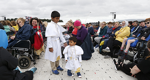 Young people dressed like Pope Francis wait for the pontiff to celebrate Mass at Phoenix Park in Dublin Aug. 26. (CNS photo/Paul Haring) See POPE-DUBLIN-MASS Aug. 26, 2018.
