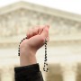 A pro-life advocate holds up a rosary outside the U.S. Supreme Court Jan. 27 during the annual March for Life in Washington. (CNS photo/Leslie E. Kossoff) See LIFE-MARCH-PARTICIPANTS Jan. 27, 2017.